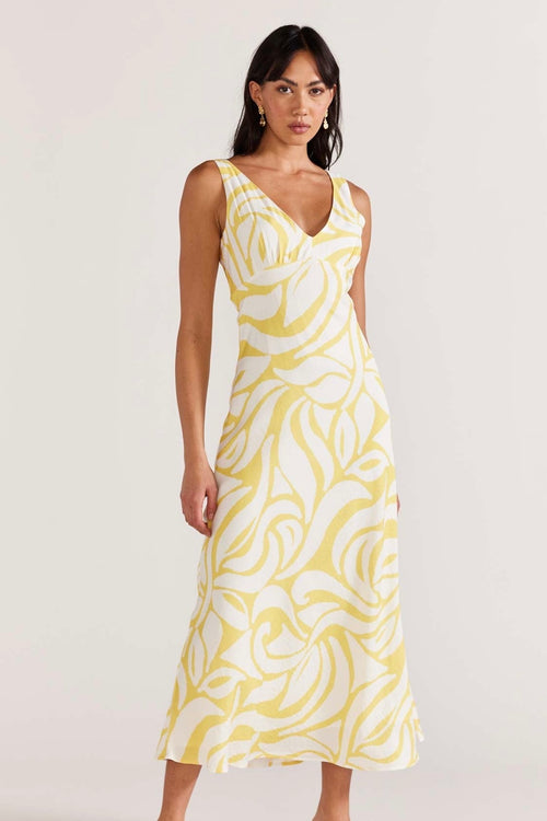 model wears yellow print maxi dress