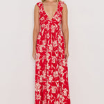 Woman wearing a red floral dress against a white background
