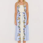 Woman wearing a floral dress with a white background