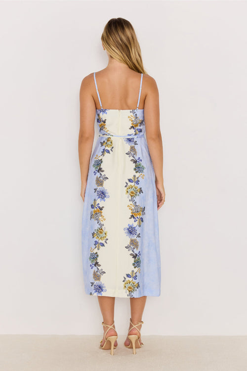 Woman wearing a floral dress with a white background