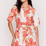 Woman wearing a floral dress with a plain background