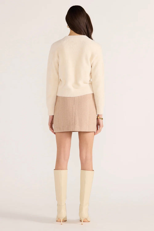 Model wears a cream fluffy long sleeve cardigan
