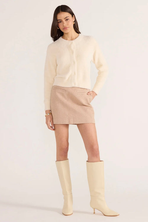 Model wears a cream fluffy long sleeve cardigan 
