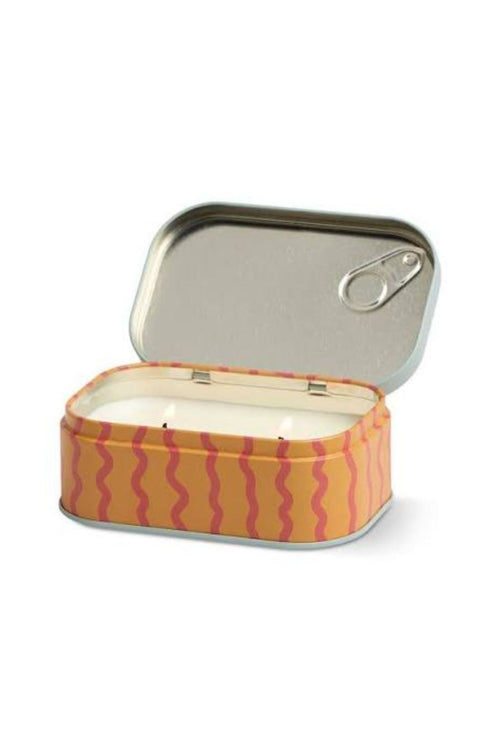 An open rectangular metal tin candle with a silver pull-tab lid, featuring a yellow-orange exterior patterned with pink wavy stripes and white wax inside.