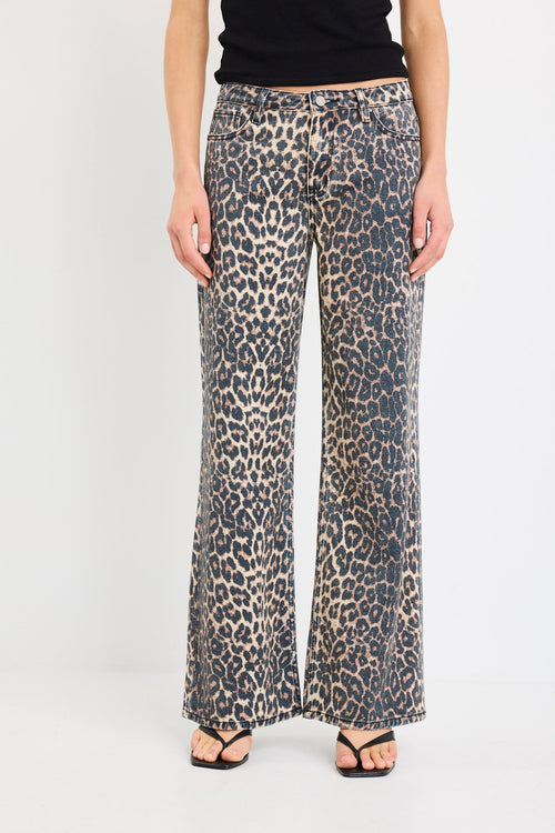 Leopard print pants worn by a person on a white background