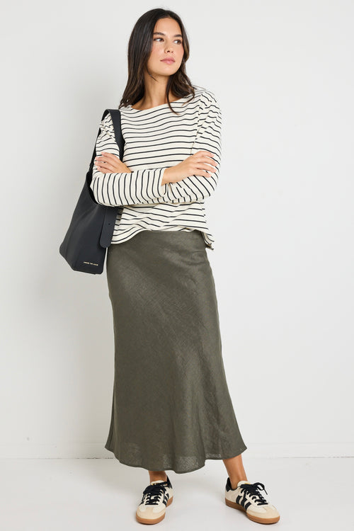 model wears a khaki linen midi skirt with waistband 