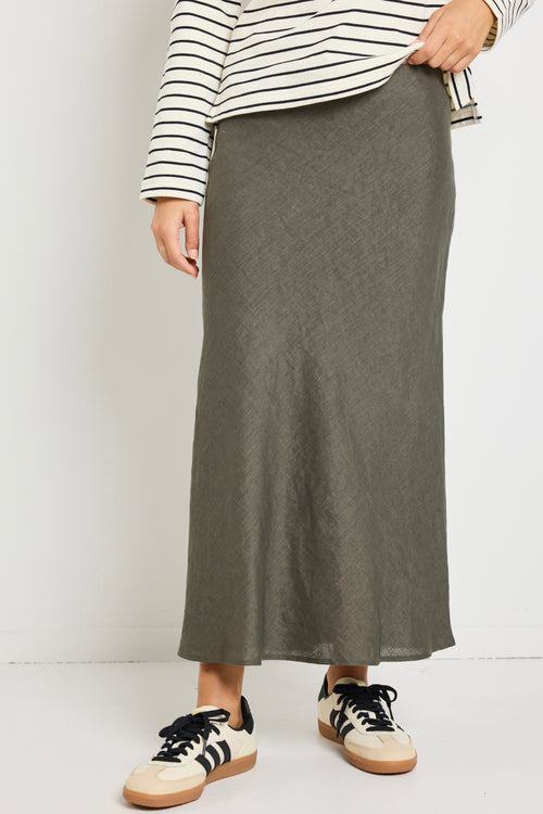 model wears a khaki linen midi skirt with waistband 