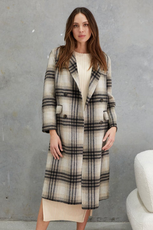 model wears a grey check wool coat