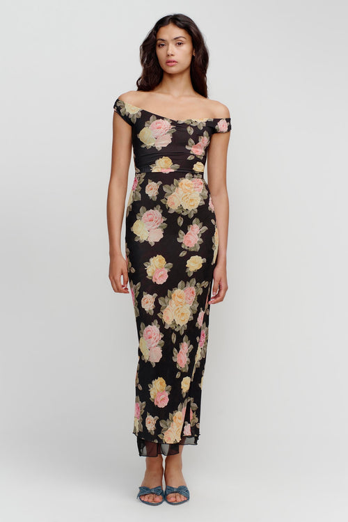 model wears a black floral maxi dress