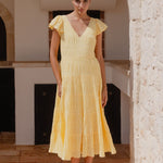 model wears a yellow flutter sleeve midi dress