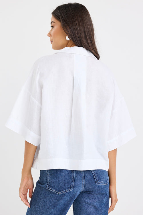 model wears a white linen boxy button up shirt