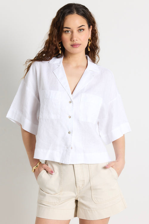 model wears a white linen shirt 