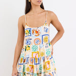 model wears a mini dress featuring a vibrant holiday print