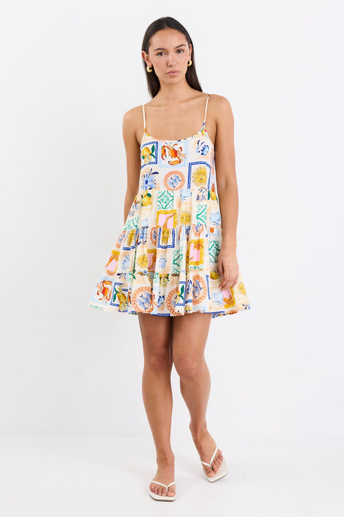 model wears a mini dress featuring a vibrant holiday print