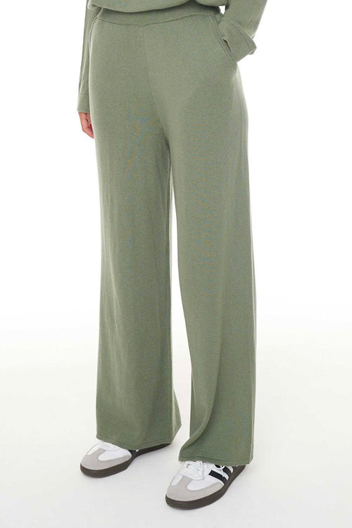 Model wears green lounge pants