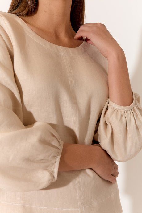 model wears a brown linen blouse