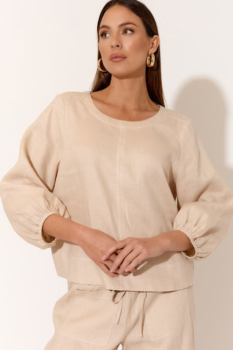 model wears a brown linen blouse