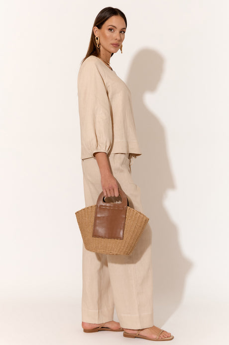 model wears a brown linen blouse