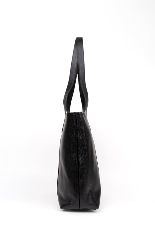 A black leather tote bag shown from a side profile view against a plain white background.