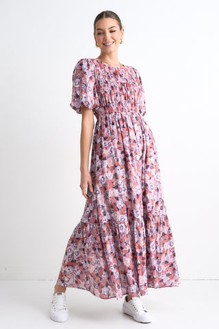 model wears a pink floral maxi dress