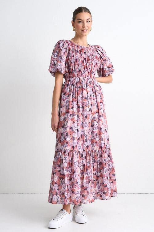 model wears a pink floral maxi dress