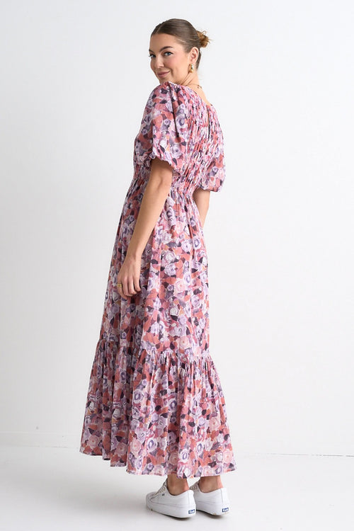 model wears a pink floral maxi dress