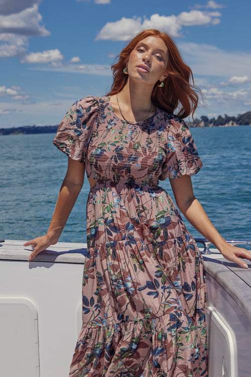 model wears a pink floral maxi dress 