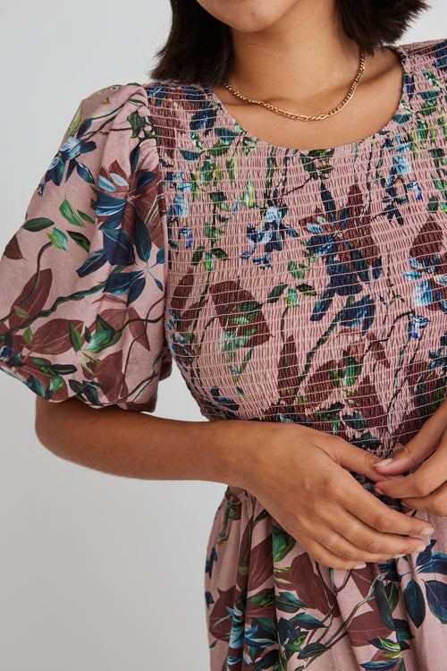 model wears a pink floral maxi dress 