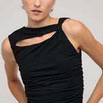 Black sleeveless top with asymmetric neckline and cutout detail, featuring a ruched body for a fitted silhouette, worn by a model against a neutral background.