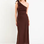 Model wearing a chocolate brown one-shoulder midi dress with a bow detail and a bias-cut skirt