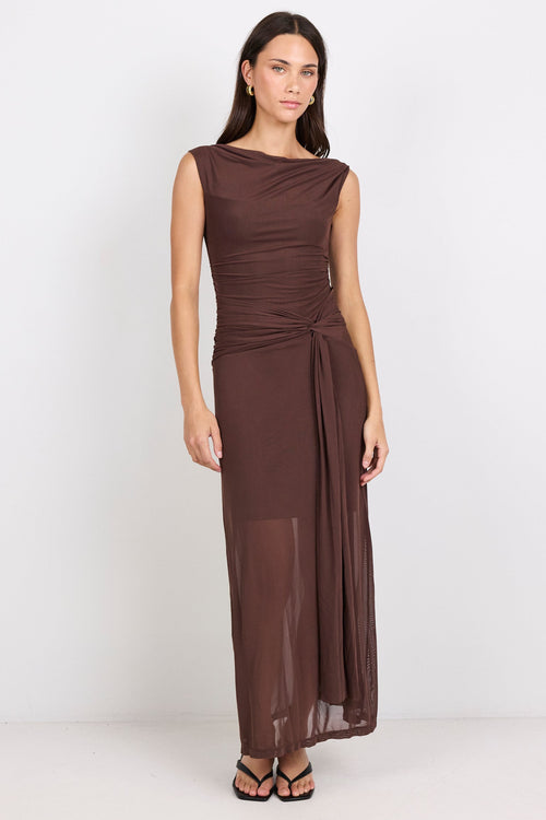 Woman wearing a brown dress on a white background