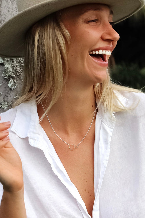 model wears a silver necklace