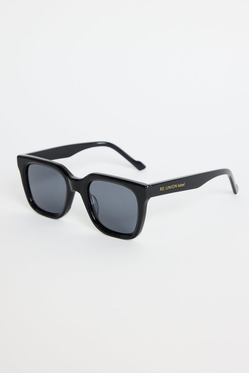 Black sunglasses with dark lenses on a white background