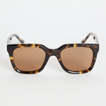 Rounded-square tortoiseshell sunglasses with warm brown tinted lenses, photographed on a white background