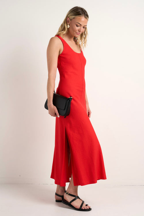 model wears a red linen maxi dress