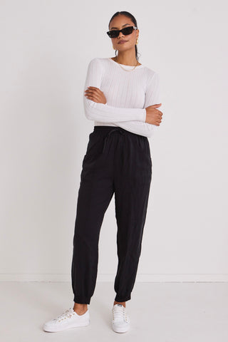 model wears a black jogger pant