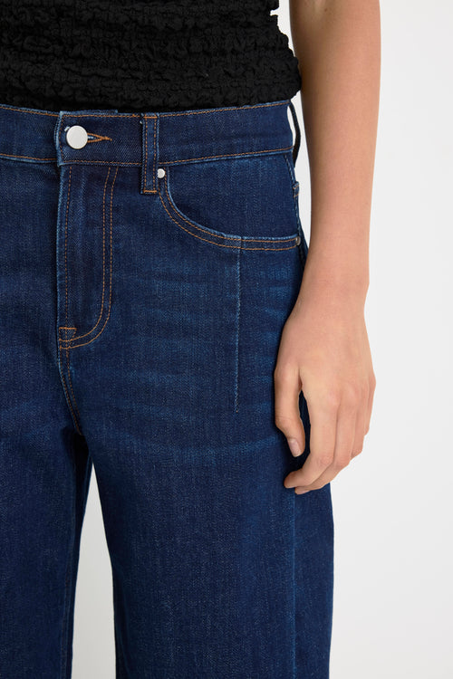 Close-up of blue jeans with a plain background