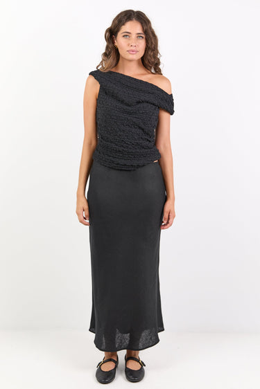 Woman wearing a black one-shoulder dress on a white background