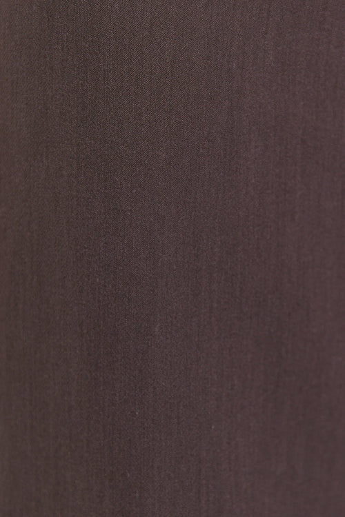 Close-up of brown pants on a white background