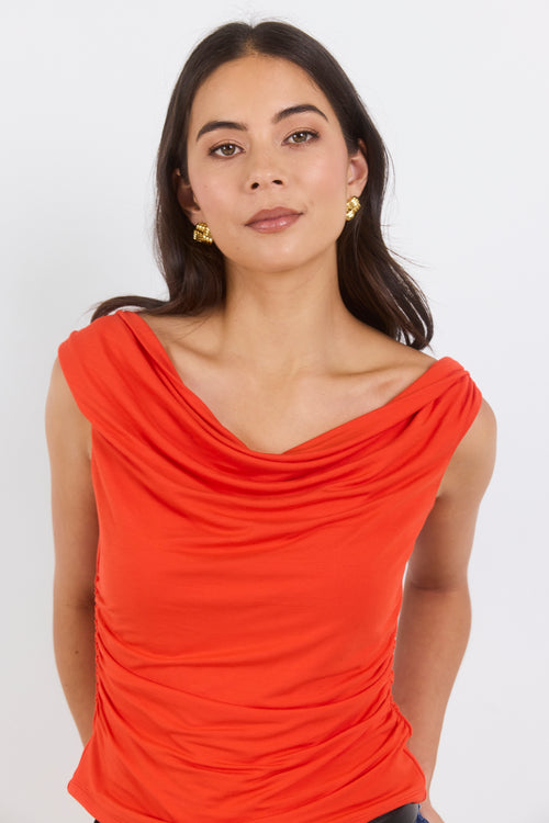 Woman wearing a red top against a white background