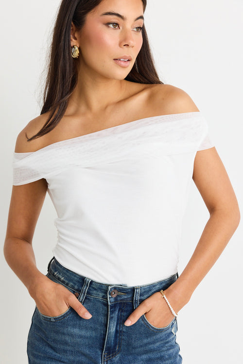 model wears a mesh white off the shoulder top