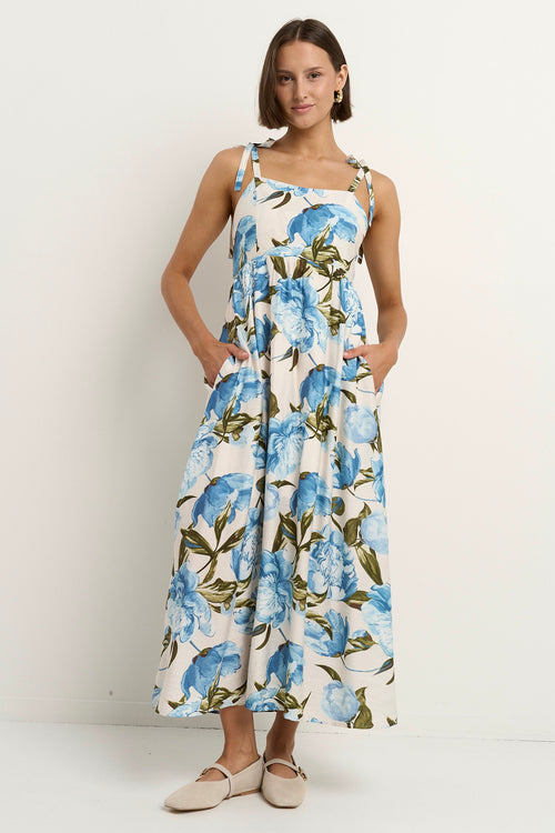 model wears a blue and white floral maxi dress 