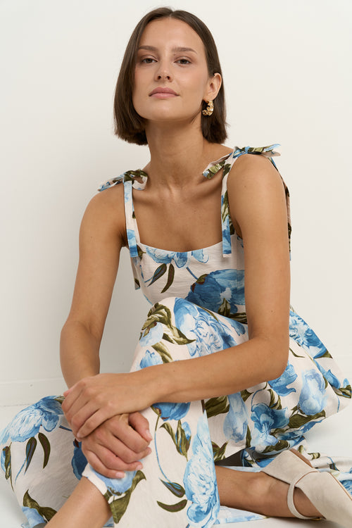 model wears a blue and white floral maxi dress 