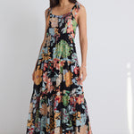 model wears a black floral maxi dress