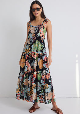 model wears a black floral maxi dress