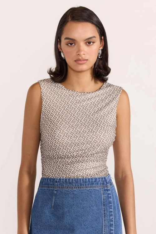 model wears beige mesh top