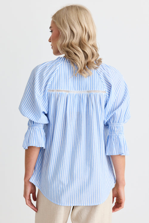 model wears a blue stripe blouse