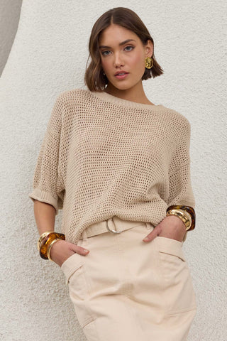 model wears a brown knit top