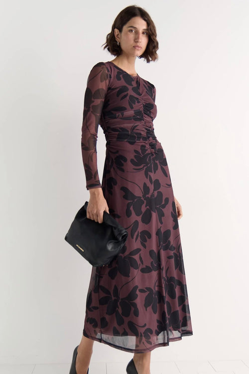 Model wears a mesh floral long sleeve maxi dress