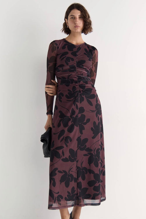 Model wears a mesh floral long sleeve maxi dress